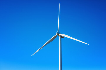 Wind turbines on a beautiful blue sky in a mountain wind farm in Sardinia. Renewable energy concept, green energy generation. Energy industry.