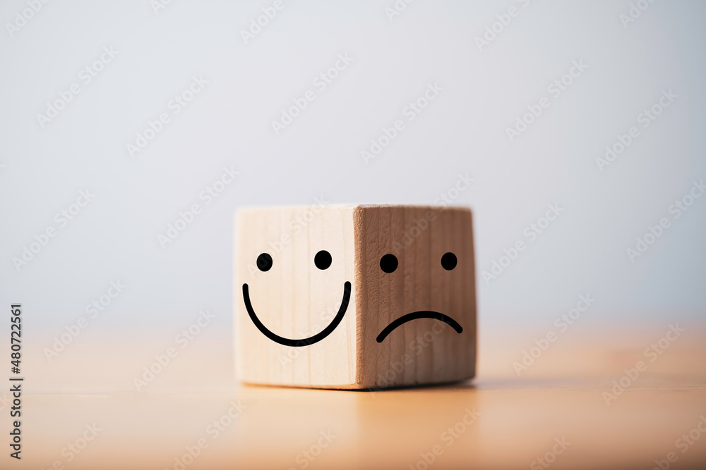 Poster Smile face in bright side and sad face in dark side on wooden block cube for positive mindset selection concept.