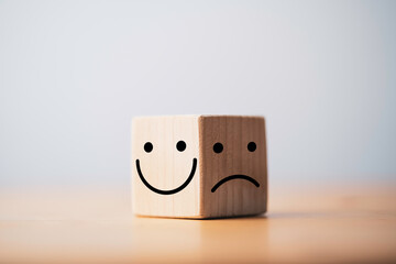 Smile face in bright side and sad face in dark side on wooden block cube for positive mindset selection concept. - obrazy, fototapety, plakaty