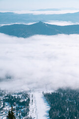 Sheregesh. Russia. Clouds covered the ski resort. Cloud among the mountains. View from above