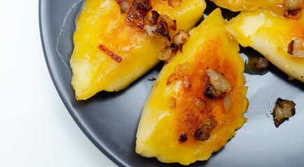 Close up of dumplings sprinkled with fried onion, traditional Polish, Russian and Ukrainian cuisine
