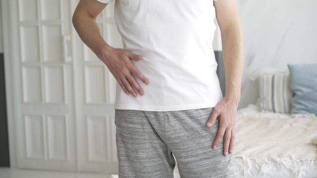 Stomach ache, man with abdominal pain suffering at home, health problems concept
