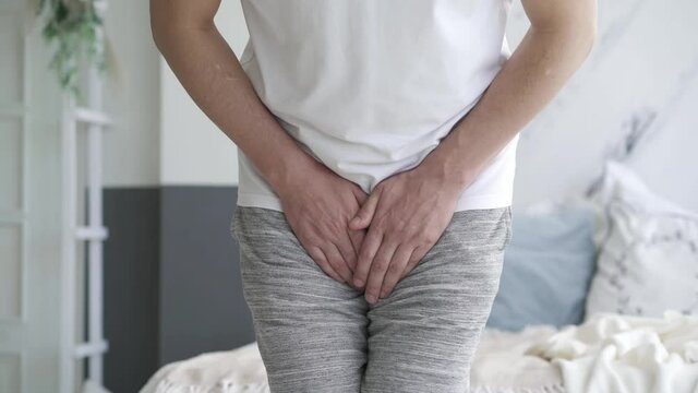 Male fertility concept, pain in prostate, man suffering from prostatitis or from a venereal disease at home, urological genital infections