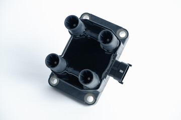 Auto parts. Car ignition coil on a white background close-up. Ignition coil for gasoline four-cylinder internal combustion engine