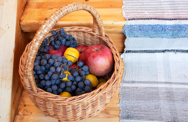 harvest of grapes, apples and quince in wicker basket