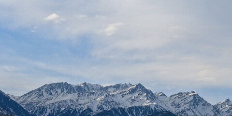 Panoramic morning shot of snow-covered peaks of the Tien Shan mountain ranges, Kazakhstan