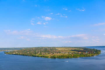 Village situated on the island . Green island surrounded by a river