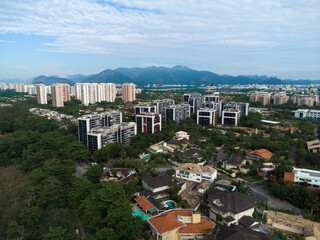 Fototapeta premium Aerial view of Barra da Tijuca. In the background hill of Rio de Janeiro, Brazil. Dawn. Sunny day with some clouds. Drone photo