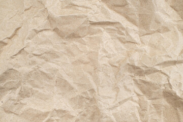 Recycled brown creased paper background from a paper packing. Crumpled brown paper texture concept