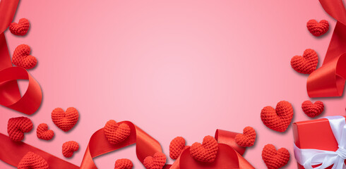 Red hearts and ribbons on pastel pink background. Valentine's Day, Anniversary, and Birthday Concepts