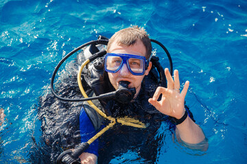 Diver man with scuba diving blue water sea. Concept travel extreme sport