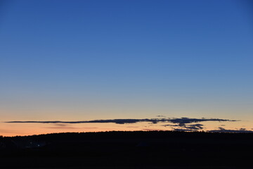 Evening moonlit rural landscape with blue sky