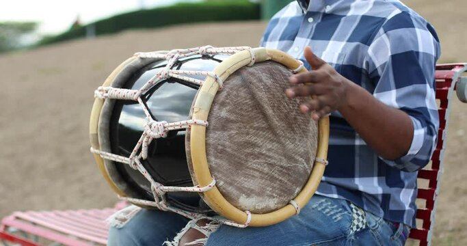 young dominican man playing tambora merengue