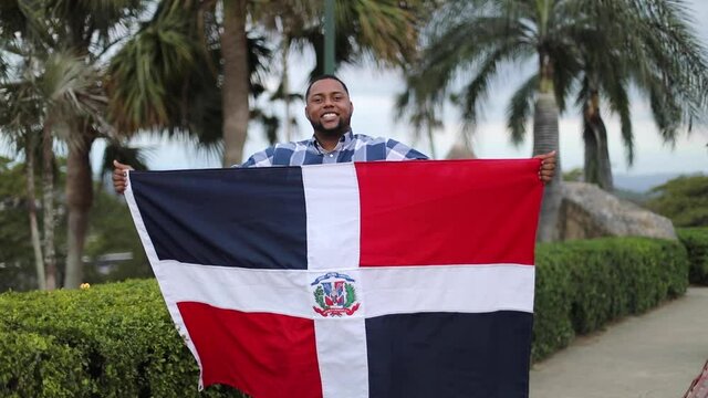 young man with dominican flag on their hands