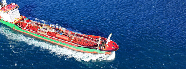 Aerial drone ultra wide photo of oil - petrochemical tanker cruising deep blue open ocean sea