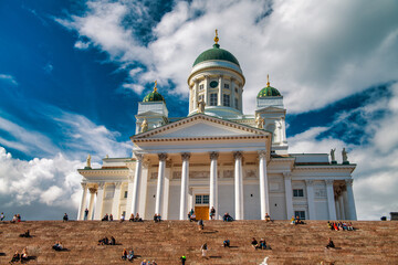 HELSINKI, FINLAND - JULY 4TH, 2017: Tourists visit Helsinki White Cathedral on a sunny day.