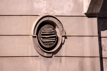 Oval rusty window with metal shaft