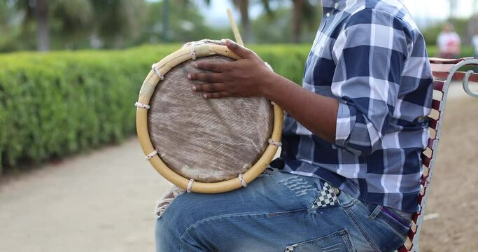 young dominican man playing tambora merengue