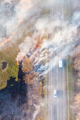 spring dry grass fire next to a busy highway; photo taken from a drone