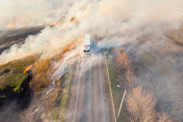 spring dry grass fire next to a busy highway; photo taken from a drone