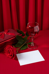 Valentine's Day blank message card with red rose and red gift box. Romantic love message.
