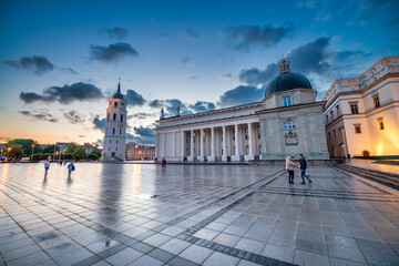 VILNIUS, LITHUANIA - JULY 9, 2017: Main landmarks and buildings at sunset in Cathedral Square. - obrazy, fototapety, plakaty