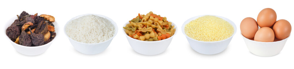 Colored pasta, chicken eggs, rice, dried fruits and couscous  in a bowl isolated on a white background.  Set of full white bowl