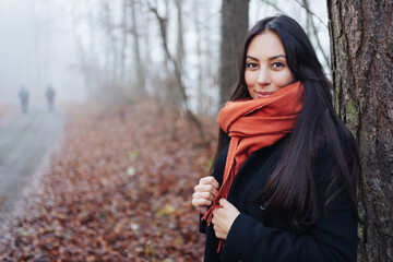 Attractive woman posing in a misty autumn park