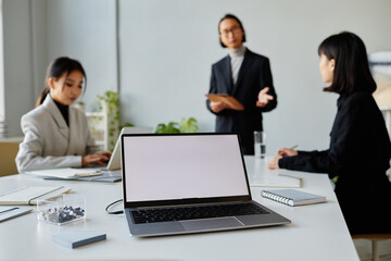 Background image of white laptop screen at meeting table in conference room, copy space