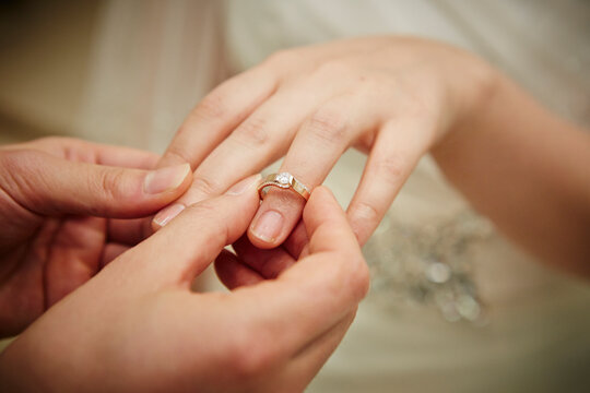 wedding rings on hands of bride