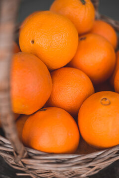 Wicker basket full of juicy ripe orange oranges - vitamin cocktail - citrus harvest season