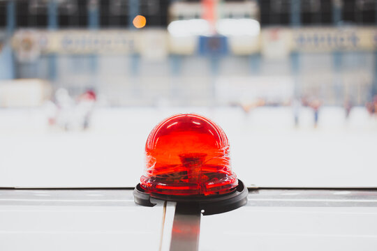 Red signal lamp on the hockey rink - a signal about the end of playing time