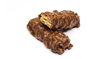 Wafers, cookies and sweets concept with hazelnut and chocolate. Cracked chocolate bar with snack wafers.