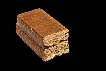 sweet chocolate biscuit wafer in focus isolated on black background