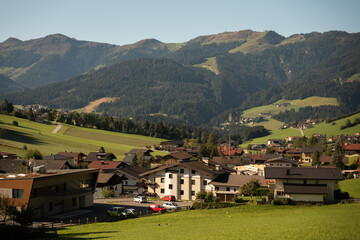 Fototapeta na wymiar Beautiful alpine landscape with green meadows, alpine cottages and mountain peaks, Austria