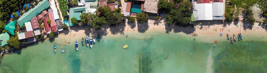 Phi Phi Don, Thailand. Overhead panoramic aerial view of Phi Phi Island coastline and beach from drone on a hot sunny day.