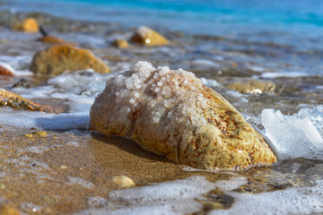 Close up of salt background. Natural salt. Dead Sea salt mineral natural formations. Salt crystals from Dead sea. View of Dead Sea coastline. Texture of Dead sea. Salty seashore rocks