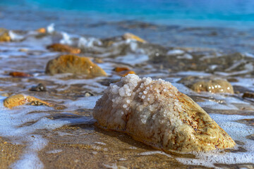Close up of salt background. Natural salt. Dead Sea salt mineral natural formations. Salt crystals from Dead sea. View of Dead Sea coastline. Texture of Dead sea. Salty seashore