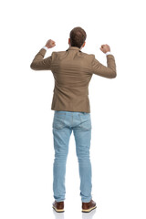 rear view of a businessman celebrating success and standing