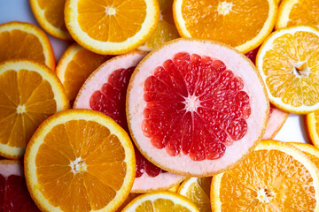 Fototapeta na wymiar Slises of different citruses on the white background. Close-up of slised citruses.