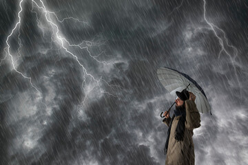 The man with  umbrella after an  storm, he is wet and dripping.