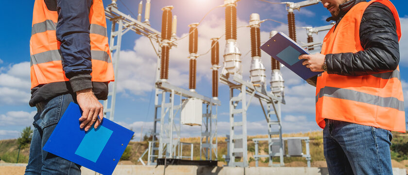 Two engineer electricians check the substation construction process