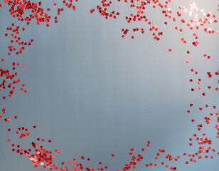 Frame of red small hearts on a blue background. Valentine's Day. Copy space. Place for text