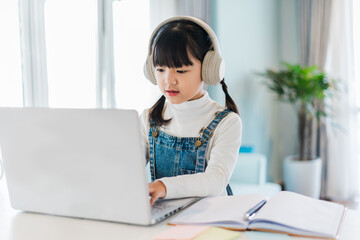 Portrait of a girl studying online at home