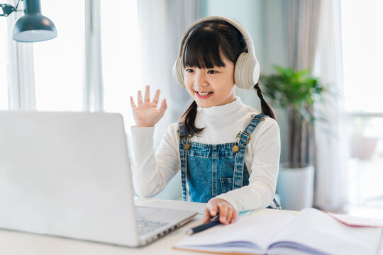 Portrait of a girl studying online at home