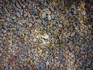 Small pebbles, brown, little sunlight.