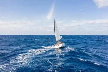Küchenrückwand glas motiv Sailing vessel on open water under clear skies in the atlantic ocean © Felix
