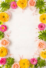 Composition of beautiful flowers, succulents and leaves on light background. Flowers frame.Top view, copy space.