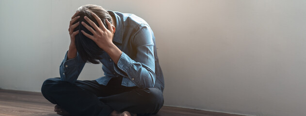 depressed teenage man sitting on the floor have a bullying problem at school