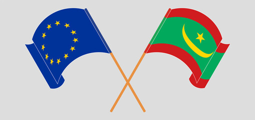 Crossed and waving flags of the European Union and Mauritania